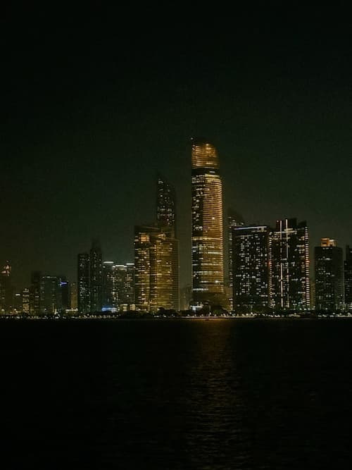 Abu Dhabi skyline at night from breakwater.